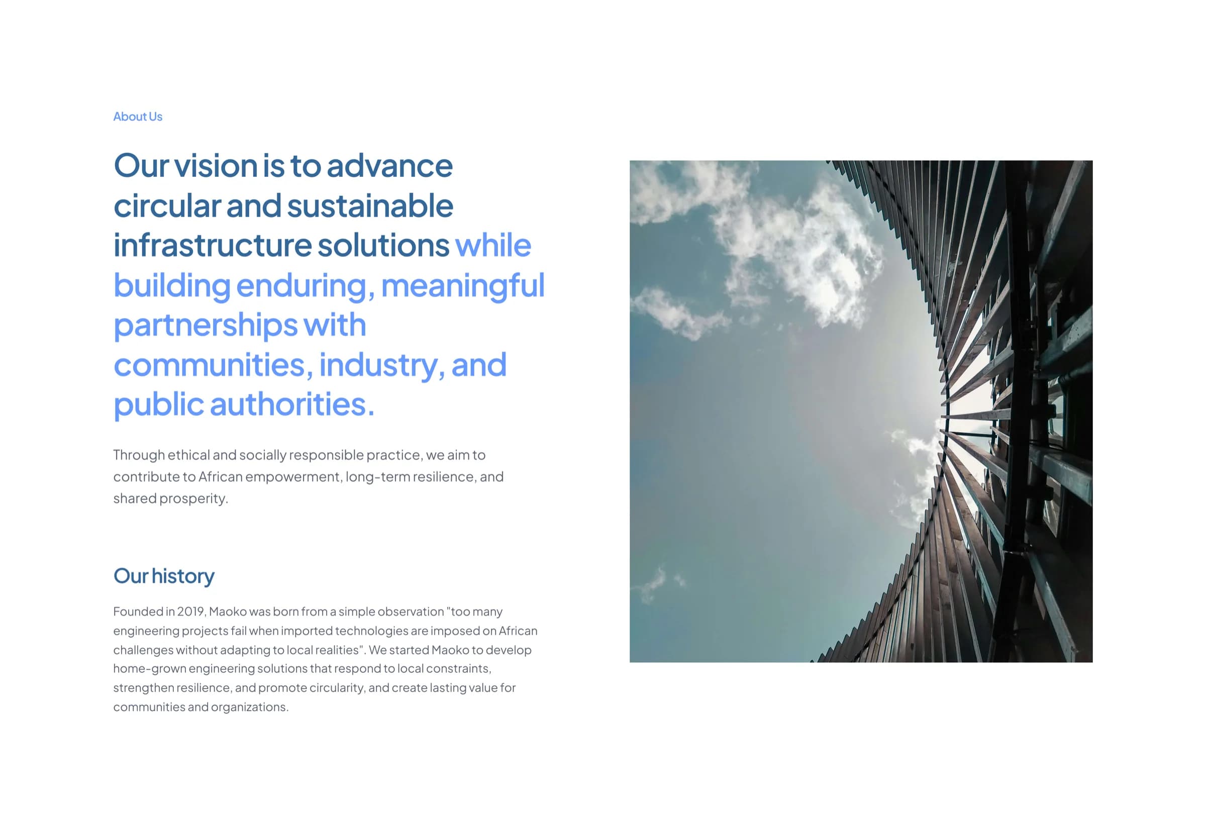 The About Us section of the Maoko Solutions site, with the firm’s vision statement set beside a photograph looking up through a water tower.